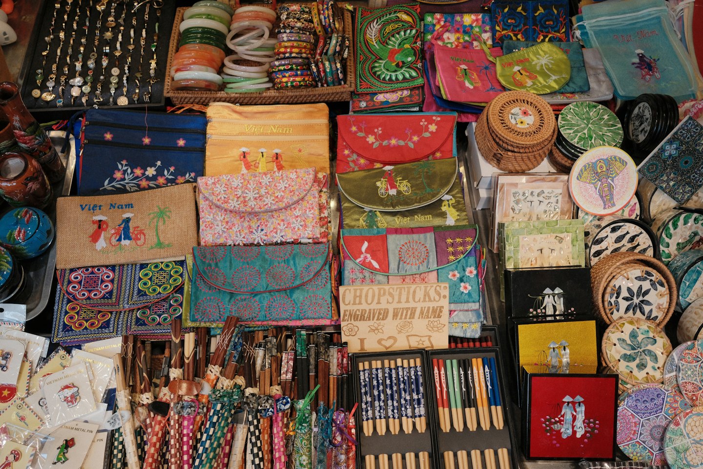Market stall display featuring various handcrafted Vietnamese souvenirs and gifts.