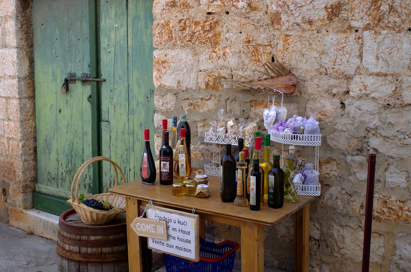 Local products sit on a wooden table beside a barrel.